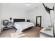 Bright bedroom with king bed, hardwood floors, and large mirror at 4810 W Mcelroy Ave # 2, Tampa, FL 33611