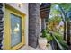 Bright yellow front door with stone accents and potted plant at 4810 W Mcelroy Ave # 2, Tampa, FL 33611