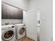 Laundry room with washer, dryer, and upper cabinets at 4810 W Mcelroy Ave # 2, Tampa, FL 33611