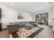 Spacious living room with gray sectional sofa, large windows, and hardwood floors at 4810 W Mcelroy Ave # 2, Tampa, FL 33611