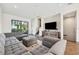 Open concept living area with sectional sofa, TV, and access to balcony at 4810 W Mcelroy Ave # 2, Tampa, FL 33611