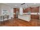 Modern kitchen featuring wood floors, a large island with light-colored cabinets, and stainless steel appliances at 534 Suwanee Cir, Tampa, FL 33606