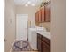 Practical laundry room with utility sink, cabinets, and washer/dryer at 5432 Layton Dr, Venice, FL 34293