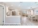 Kitchen and dining area with white cabinets, stainless steel appliances, and wood-look flooring at 5875 Bay Pines Lakes Blvd, St Petersburg, FL 33708