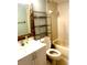 Bathroom with tub, toilet and shelving at 6322 Palma Del Mar S Blvd # 106, St Petersburg, FL 33715