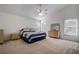 Bedroom featuring large windows, ceiling fan, and coordinated bedroom furniture at 8620 Brookway Cir, Tampa, FL 33635