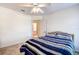 Bedroom with striped bedding and access to bathroom at 8620 Brookway Cir, Tampa, FL 33635