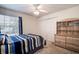 Bedroom with striped bedding and ceiling fan at 8620 Brookway Cir, Tampa, FL 33635