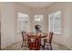 Cozy dining area with a round wooden table and a view through the bay window at 8620 Brookway Cir, Tampa, FL 33635