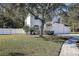 Two-story house with white exterior, landscaped yard, and driveway at 8620 Brookway Cir, Tampa, FL 33635
