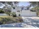 A charming two-story home featuring a three-car garage and lush front yard at 8620 Brookway Cir, Tampa, FL 33635