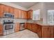 Kitchen boasting stainless steel appliances, granite countertops, and wood cabinets at 8620 Brookway Cir, Tampa, FL 33635