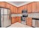 Spacious kitchen with stainless steel appliances, wood cabinets, and tile backsplash at 8620 Brookway Cir, Tampa, FL 33635