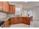 Eat-in kitchen with granite countertops and wood cabinets at 8620 Brookway Cir, Tampa, FL 33635