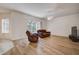 Comfortable living room featuring wood floors, leather seating, and a ceiling fan at 8620 Brookway Cir, Tampa, FL 33635