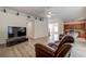 Open living room with hardwood floors and a view of the kitchen at 8620 Brookway Cir, Tampa, FL 33635
