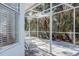 Relaxing screened porch with patio furniture, overlooking a lush natural landscape at 8620 Brookway Cir, Tampa, FL 33635