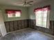 Empty bedroom with exposed framing and pink curtains on the windows at 914 Sago Palm Way, Apollo Beach, FL 33572