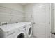 Laundry room with LG washer and dryer and ample shelving at 11908 Whisper Creek Dr, Riverview, FL 33569