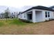 Backyard with a covered patio and green lawn at 16851 Forge Surf St, Land O Lakes, FL 34638