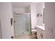 Modern bathroom with a walk-in shower, white vanity, and light tile flooring at 16851 Forge Surf St, Land O Lakes, FL 34638