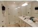 Modern bathroom with glass shower, double vanity, and white tile at 16851 Forge Surf St, Land O Lakes, FL 34638