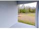 Covered back patio overlooking a community pond and trees at 16851 Forge Surf St, Land O Lakes, FL 34638
