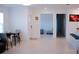 Dining area and living room with access to the kitchen, featuring light tile flooring at 16851 Forge Surf St, Land O Lakes, FL 34638