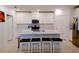 Modern white kitchen with an island, stainless steel appliances, and white countertops at 16851 Forge Surf St, Land O Lakes, FL 34638