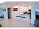Spacious kitchen and living area with white cabinets, an island, and stainless steel appliances at 16851 Forge Surf St, Land O Lakes, FL 34638