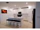 Modern kitchen featuring white shaker cabinets, stainless steel appliances, and an island with bar seating at 16851 Forge Surf St, Land O Lakes, FL 34638