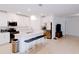 Open-concept kitchen and living area with white cabinetry, a center island, and stainless steel appliances at 16851 Forge Surf St, Land O Lakes, FL 34638