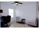 Home office or den with two armchairs, a small table, and an office chair at 16851 Forge Surf St, Land O Lakes, FL 34638