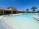 Large community pool with a zero-entry area and a clubhouse in the background at 20363 Symphony Pl, Venice, FL 34293