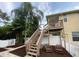 Backyard with wooden stairs leading to a deck at 3020 Sheppards Crook Ct, Holiday, FL 34691