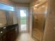 Bathroom with walk-in shower, tile flooring, and access to balcony at 3020 Sheppards Crook Ct, Holiday, FL 34691