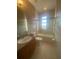 Clean bathroom with a bathtub, toilet and sink at 3020 Sheppards Crook Ct, Holiday, FL 34691