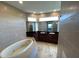 Bathroom with double vanity, soaking tub, and tile flooring at 3020 Sheppards Crook Ct, Holiday, FL 34691