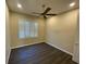 Spacious bedroom with dark hardwood floors and a ceiling fan at 3020 Sheppards Crook Ct, Holiday, FL 34691