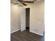 Bedroom with a walk-in closet and dark hardwood floors at 3020 Sheppards Crook Ct, Holiday, FL 34691