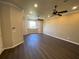 Spacious bedroom with wood-look flooring, large window, and ceiling fan at 3020 Sheppards Crook Ct, Holiday, FL 34691