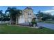Two-story house with a three-car garage and landscaped yard at 3020 Sheppards Crook Ct, Holiday, FL 34691