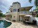 Multi-level home with pool, patio, and outdoor dining area at 3020 Sheppards Crook Ct, Holiday, FL 34691