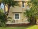 Tan house exterior with landscaping at 3020 Sheppards Crook Ct, Holiday, FL 34691