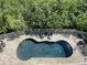 Aerial view of kidney-shaped pool with surrounding patio at 3020 Sheppards Crook Ct, Holiday, FL 34691