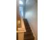 Modern staircase with dark hardwood floors and window at 3020 Sheppards Crook Ct, Holiday, FL 34691