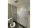 Modern bathroom with marble tile shower and white fixtures at 3349 Overland Dr, Holiday, FL 34691
