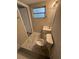 Bathroom with marble tile floor, white vanity, and toilet at 3349 Overland Dr, Holiday, FL 34691