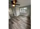 Empty bedroom with gray walls, wood-style flooring, and ceiling fan at 3349 Overland Dr, Holiday, FL 34691