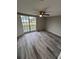 Large bedroom with lots of natural light, wood-look flooring and ceiling fan at 3349 Overland Dr, Holiday, FL 34691
